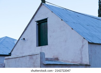 Old Plastered Farmhouse With Attic Door Abstract