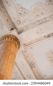 Old plastering of the ceiling of the palace with columns.