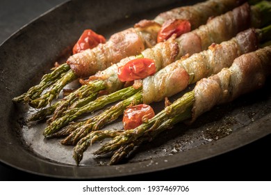 An old platter with delicious bacon wrapped asparagus. - Shutterstock ID 1937469706