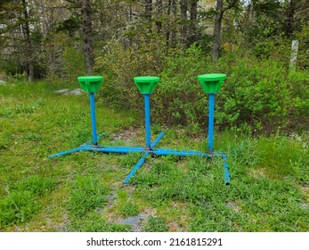 Old Playground Equipment Left In Some Grass.