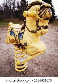 An Old Playground Yellow Rocking Horse