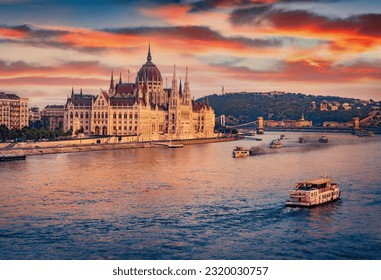 Old pleasure boats on Dunabe river with Parliament house on background. Stunning summer cityscape of Budapest. Amazing sunset in Hungary, Europe. Traveling concept background. - Powered by Shutterstock