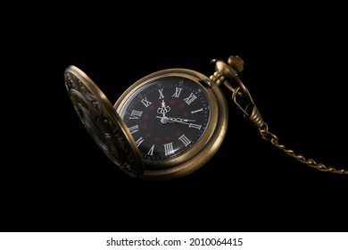 old pocket mechanical watch isolated on black background. fashoinable and antique accessory.