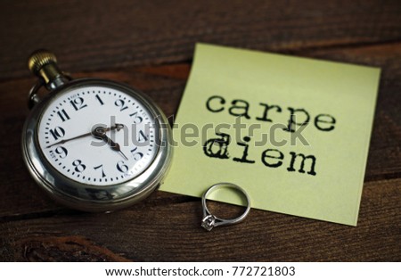 Old pocket watch, ring and note of carpe diem