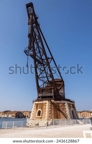 Old port crane at the Venetian Arsenal (Arsenale di Venezia) a complex of former shipyards and armories, Venice, Italy