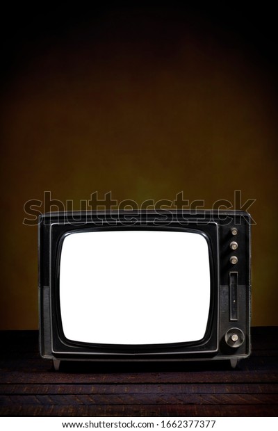 Old portable\
television, with blank screen. Wooden table and brown background.\
Vertical version. Concept of obsolescence, modernization or\
technological revolution