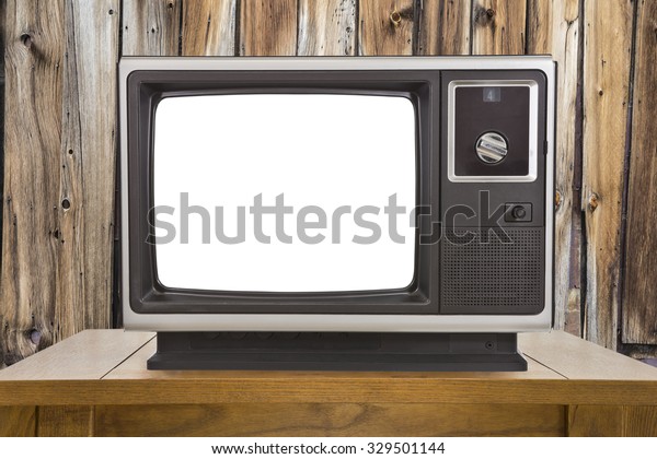 Old portable television with cut out screen and
rustic wood wall.