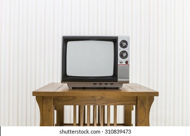Old portable television on wood table.