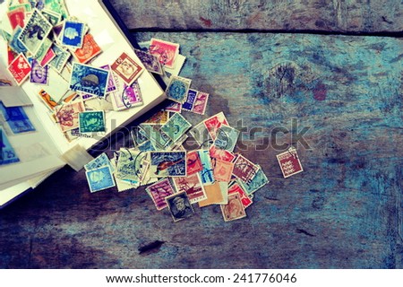 Old post stamps on a wooden background