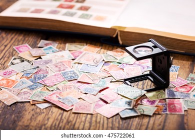 Old postage stamps from various countries on wooden table - Powered by Shutterstock