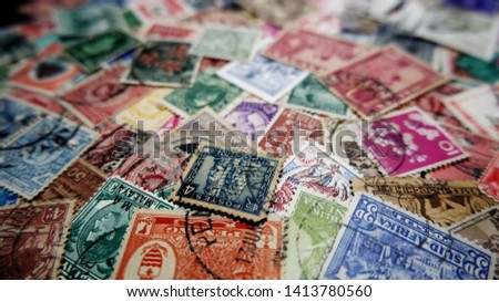 Old postage stamps from various countries as background.