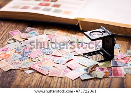 Old postage stamps from various countries on wooden table