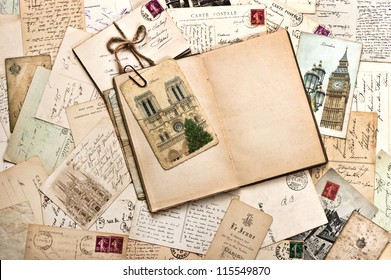 old postcards and open empty book. vintage travel background