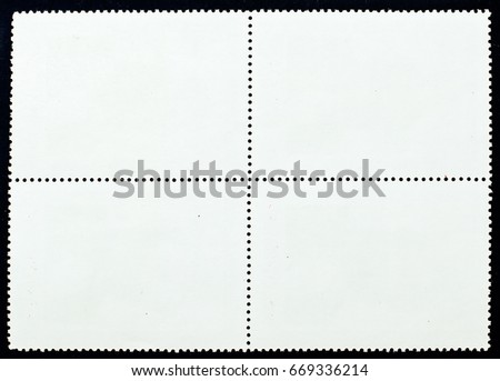 Old posted stamp block reverse side isolated on black background