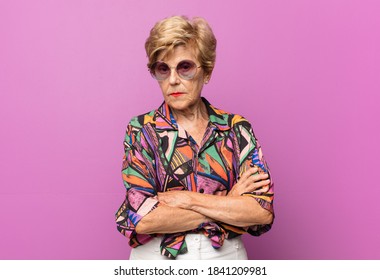 Old Pretty Woman Feeling Displeased And Disappointed, Looking Serious, Annoyed And Angry With Crossed Arms