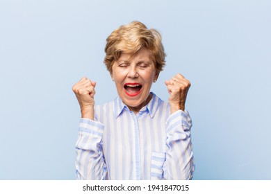 Old Pretty Woman Feeling Shocked, Excited And Happy, Laughing And Celebrating Success, Saying Wow!