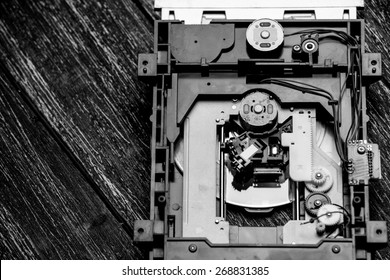 Old Printed Circuit Board Of CD Player. Photo In Old Color Image Style.