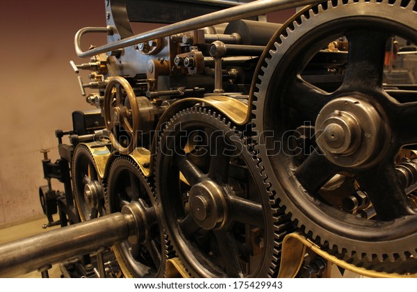 Old printing press - rotary machine - polygraphic\
equipment - big cog wheel