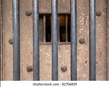 Old Prison Door With Metal Bars And Open Window