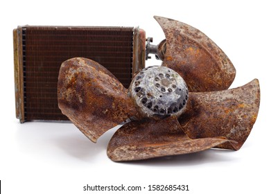 Old Propeller With Pile Of Scrap Metal And Radiator Isolated On A White Background.