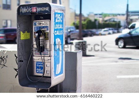 Old Public Pay Phone next to a Parking Lot