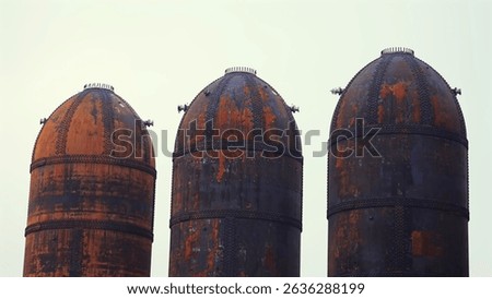 Old pulp mill paper mill digester tanks rusted close up