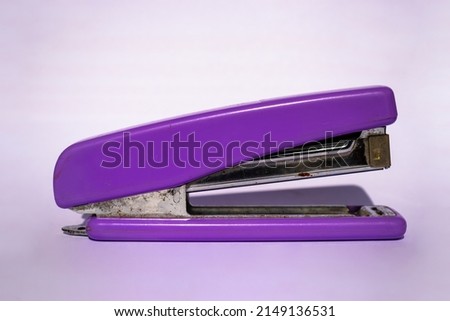 Old purple stapler which is still good but is starting to rust.