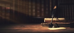 Old Quill Pen With Inkwell And Papers On Wooden Desk Against Vintage Bookcase. Retro Style. Banner Copy Space