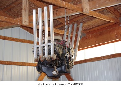 Old Racing Car V 8 Engine Hanging From Rafter In A Barn