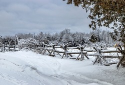 An Old Rail Fence Covered In Snow