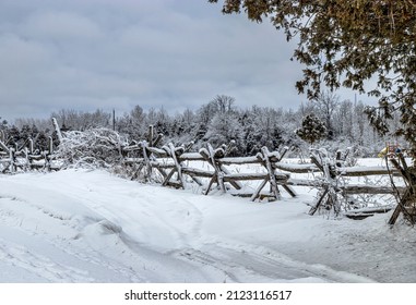 An Old Rail Fence Covered In Snow