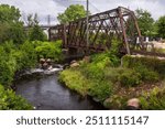 An old railroad bridge crossing a river in town.