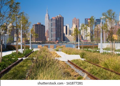 Old Railroad Tracks And View Of New York City Skyline At Gantry Plaza State Park