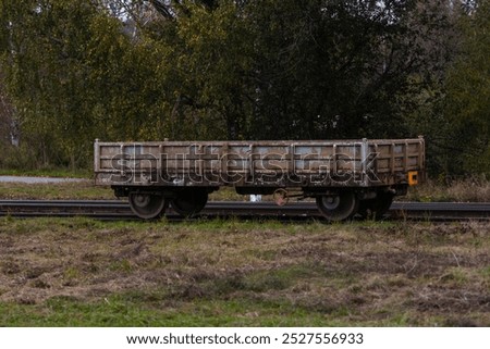 Old railway carriage, iron rusts, overgrown place