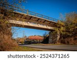 Old Railway Concrete bridge over a rural road during autumn