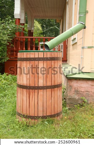 Old rainwater barrel near house, Russia