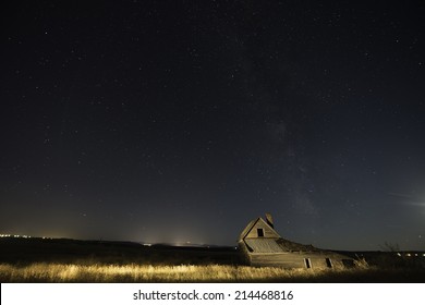 Old Ranch House In Belle Fourche, South Dakota With Night Sky Filled With Stars.