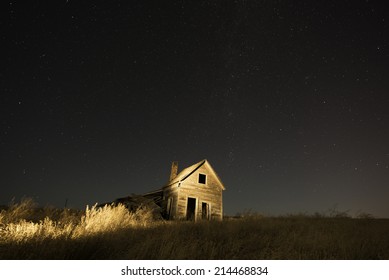 Old Ranch House In Belle Fourche, South Dakota With Night Sky Filled With Stars.