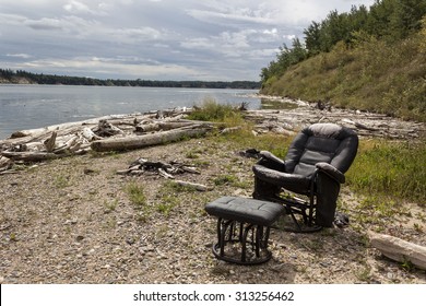 Old Recliner Chair And Foot Stool Sitting By A Lake