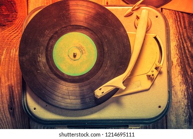Old record player with a stack of vinyl records