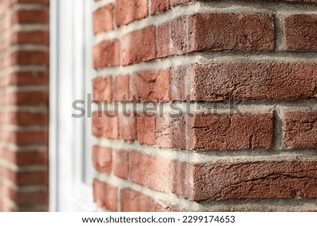 Old red brown brick wall with diminishing perspective. Detail of brick house inn sunny day.