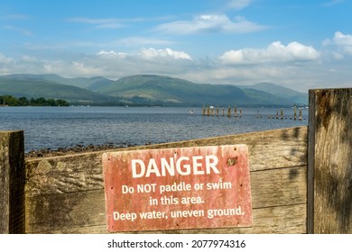 An Old Red Danger, Do Not Paddle Or Swim Warning Sign At Loch Lomond, Scotland