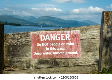 An Old Red Danger, Do Not Paddle Or Swim Warning Sign At Loch Lomond, Scotland