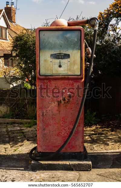 Old red derelict\
petrol pump, no logo.