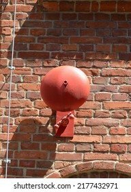 Old Red Factory Or Fire Alarm On A Red Brick Wall; The Old Bell In The Factory, Used For Alarm, Signaling A Work Interruption, End Of Shift