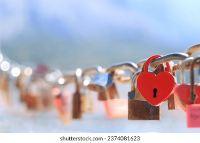 Old red heart shaped lock. Love lock on the bridge. Close up of lock and key hole. Red love padlock. Valentines day. Makarska Croatia. Red metal padlock heart of lovers. Greeting card 