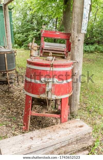 old red painted washing\
machine