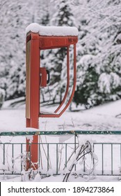 Old Red Phone Booth In Snow