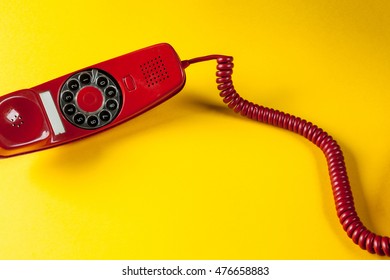 Old Red Phone Off The Hook On Yellow Background