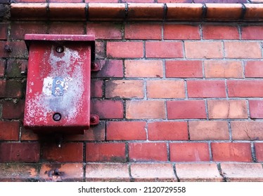 Old Red Rick Wall With A Weathered Metal Box. Texture Of Old Weathered Brick Wall Panoramic Background.